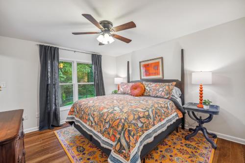 a bedroom with a bed and a ceiling fan at Trailblazer Lodge - Upscale, hot tub, trail, game room, wifi, fire pit, bar, pool table, king bed, view, pet friendly in Berkeley Springs
