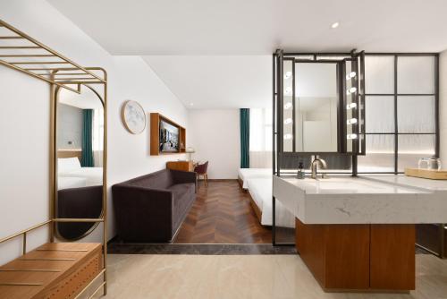 a bathroom with a sink and a living room at Chinese Culture Boutique Hotel TangFu, Liangma Riverside, Near Sanlitun & Embassy Area, Metro Access, 20min to Wangfujing, Forbidden City & Tian'anmen Square, Airport & the Great Wall Travel Assistance in Beijing