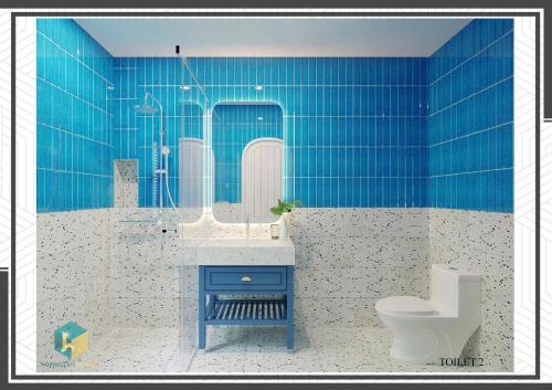a blue bathroom with a toilet and a sink at Villa Malibu Tropicana Hồ Tràm in Xuyên Mộc