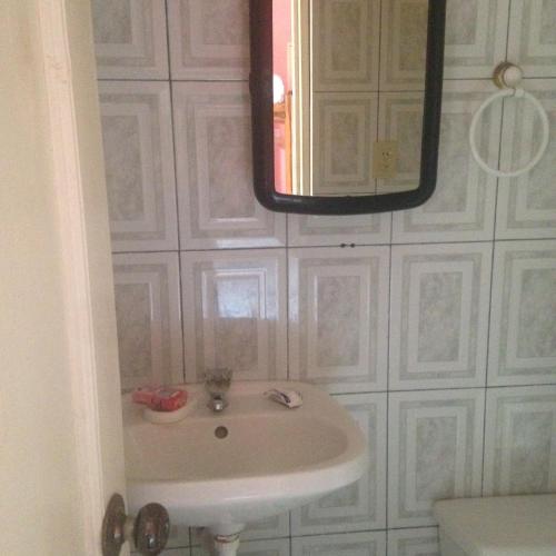 a bathroom with a sink and a mirror at Hostal Camping Beach in Salinas