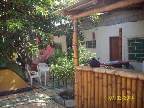 a backyard with a wooden fence and a table and a chair at Hostal Camping Beach in Salinas