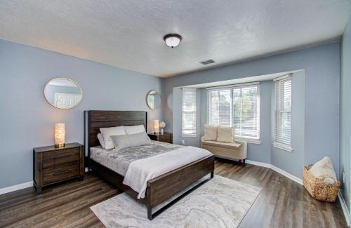 een slaapkamer met een bed, een stoel en ramen bij Heated Pool • Hot Tub • Game Loft • 4BR in Atascocita