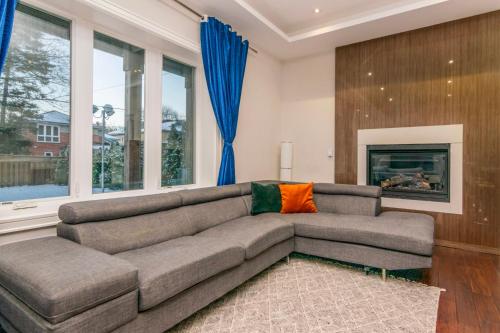 a living room with a couch and a fireplace at Hillcrest Modern House in Toronto