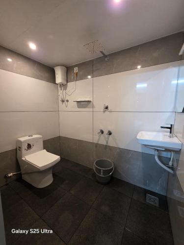 a bathroom with a toilet and a sink at SR Residency in Kollam