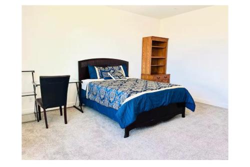 a bedroom with a bed and a desk and a chair at Cozy Private master bedroom in a single family house in Elk Grove