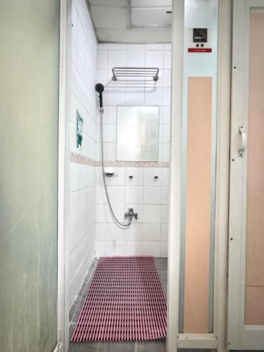 a bathroom with a shower with a red tile floor at 신사 여성전용 개인 미니룸 Female Only Private Mini Room Gosiwon 2pm ckeck in 11am ckeck out address 강남구 논현동6-8 BESTEL, Check the message for the check in in Seoul