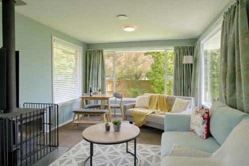 a living room with a couch and a table at Cotswold Retreat in Christchurch