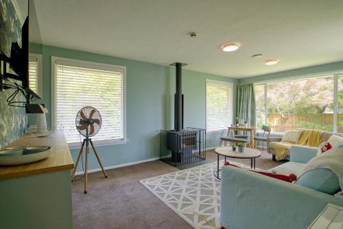 a living room with a couch and a table at Cotswold Retreat in Christchurch