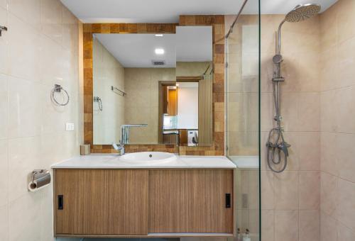 a bathroom with a sink and a shower at Rare Panoramic Sea, City & Mountain Views - XXL Balcony - 1Gbps Blazing Fast Free WIFI - Pool - Gym - Pool Table - Steam - Sauna - Bar in Pattaya South