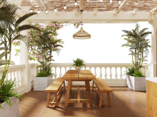 a table in a room with potted plants at Indochine Gloria Home by Silk Path in Hanoi