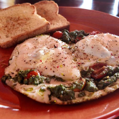 un piatto rosso di cibo con uova e pane tostato di 360 Agonda ad Agonda