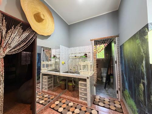 a bathroom with a sink and a mirror at Beachfront bungalow south of Phuket in Phuket Town