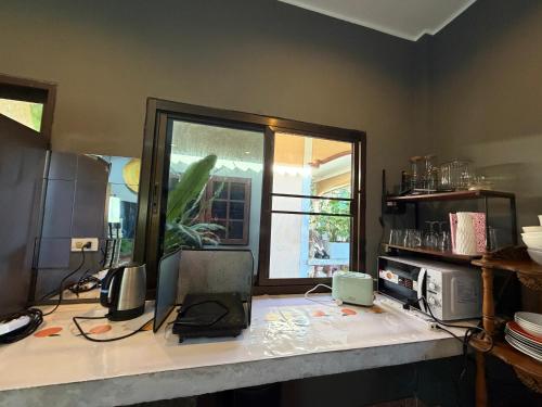 a kitchen with a counter with a laptop on it at Beachfront bungalow south of Phuket in Phuket Town