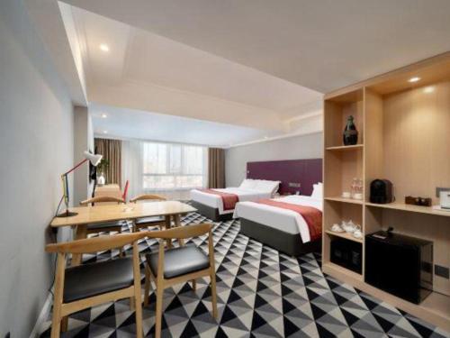 Ένα ή περισσότερα κρεβάτια σε δωμάτιο στο Longda Ruiji Business Hotel Harbin