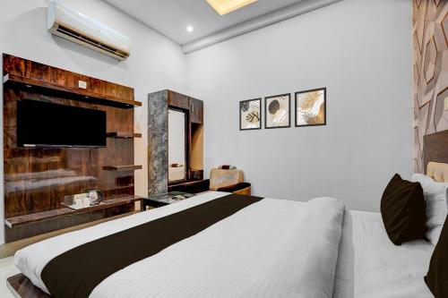 a bedroom with a bed and a flat screen tv at Collection ORudrapurBus StandFormerly Corinthian in Rāmpura