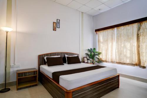 a bedroom with a bed and a window at Palette Hotel And Resort Garikhana Shillong Formerly Council Lodge in Shillong