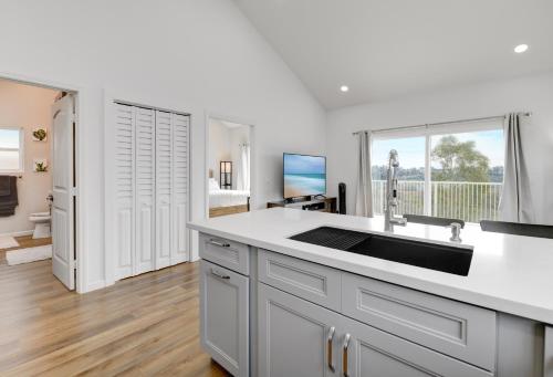 a kitchen with a sink and a large window at Bright Spacious Modern Getaway in San Diego