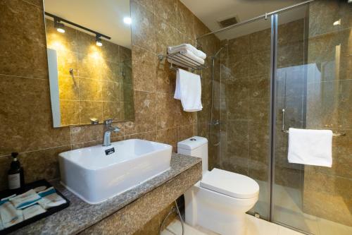 a bathroom with a sink and a toilet and a shower at Hawaii Resort Phu Quoc in Phu Quoc