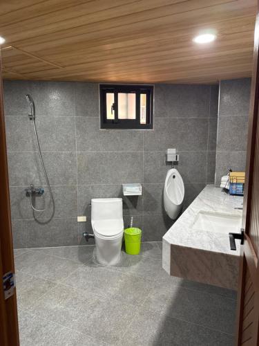 a bathroom with a toilet and a sink and a shower at Royal Court B&B in Donggang