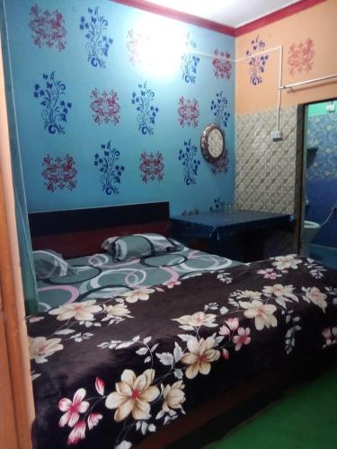 a bedroom with a bed with flowers on it at Nk brothers,Joshimath in Joshīmath