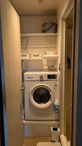 a washer and dryer in a small room at El Amarillo SELF CHECK IN HOSTEL in Fukushima
