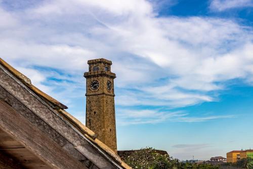 a clock tower on top of a building at La Muraille, Galle Fort in Galle