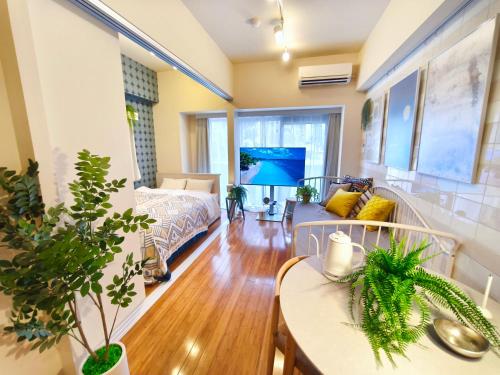 a living room with a couch and a table at Nishiki Stay Takamatsu101 in Takamatsu