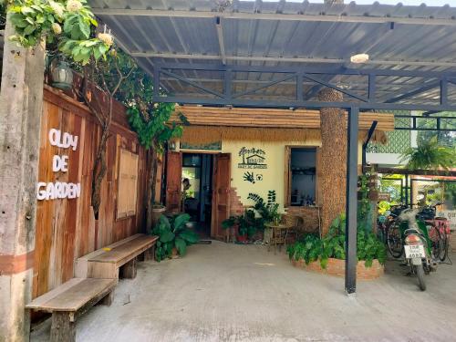 a building with a bench and a sign on it at Oldy De Garden in Chiang Mai