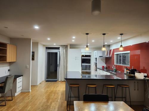 a kitchen with a large island in a room at Peninsular Lakefront in Queenstown