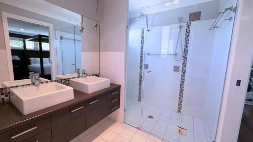 a bathroom with two sinks and a shower at Station on Pearce in Coffs Harbour