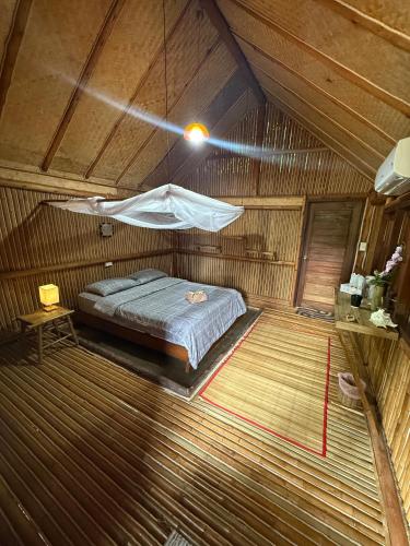 a bedroom with a bed in a wooden room at Bamboo Hideaway Resort in Ko Mak