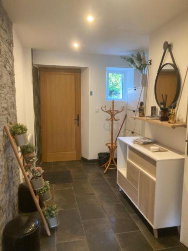a kitchen with a tile floor and a door at Moulin entier rénové in Plounéventer