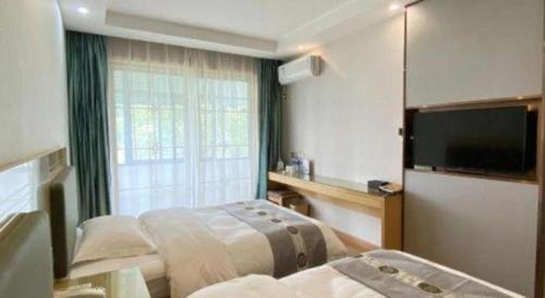 Ένα ή περισσότερα κρεβάτια σε δωμάτιο στο Shell Hefei Luyang District Sipai Building Subway Station Hotel