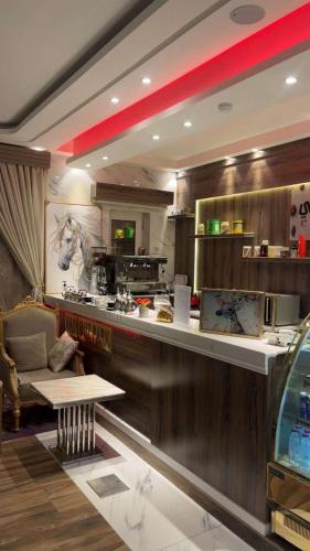 a kitchen with a bar with a counter top at نيروز بارك in Najran