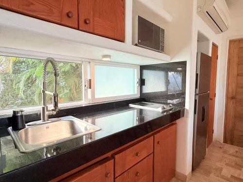 a kitchen with a sink and a window at Departamentos Frente al Mar en Ixtapa in Ixtapa
