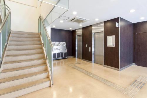 a staircase in a building with a stair case at Comfort Hotel Kokura in Kitakyushu