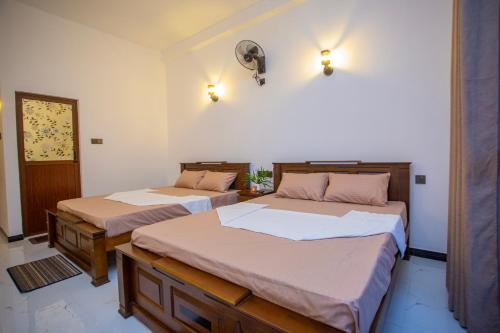 two beds in a room with two at The Cloud Nest Villa in Ahangama