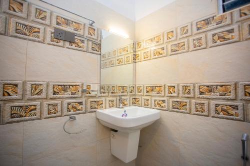 a bathroom with a toilet and a sink at The Cloud Nest Villa in Ahangama