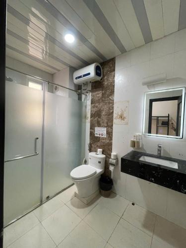 a bathroom with a shower and a toilet and a sink at Khách Sạn Thủ Đô Hanoi Capital Hotel in Hanoi