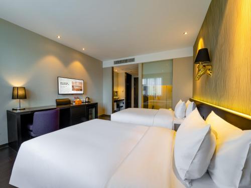 Postel nebo postele na pokoji v ubytování Orange Hotel Hangzhou West Lake Hefang Street