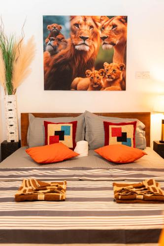 a bedroom with a bed with a painting of lions at Singha Residences Thalawathugoda in Bokundara