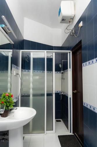 a bathroom with a shower and a sink at Singha Residences Thalawathugoda in Bokundara