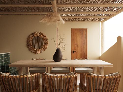 a dining room with a table with chairs and a mirror at PhaTea Neoclassical Style Building - near Old Quarter in Hanoi