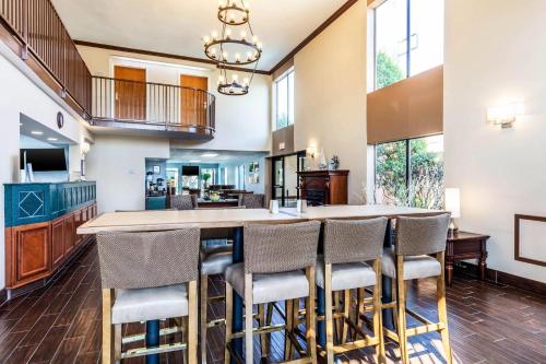 a large kitchen with a large table and chairs at Quality Suites Paducah I-24 in Paducah