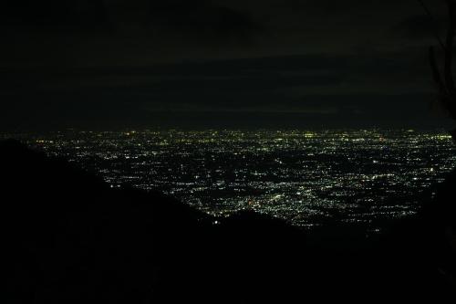 a view of a city lit up at night at Moksha at Infinity Valley in Kotagiri