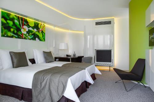 a bedroom with a large bed and a television at Radisson Blu Hotel & Convention Centre Kigali in Kigali