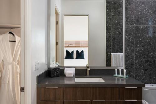 a bathroom with a sink and a mirror at Cobalt @ Elemento49 Pool Spa Sleeps 16 in Desert Groves Mobile Home Park