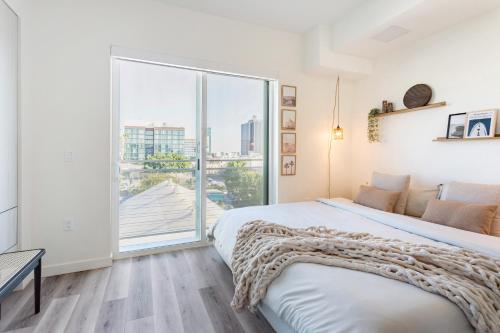 a bedroom with a bed and a large window at Boutique Mini 1 BD Residence in Los Angeles