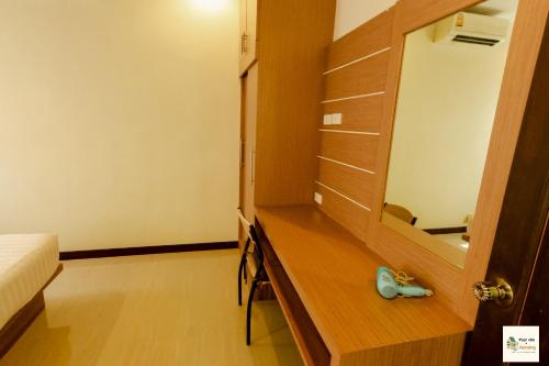 a bedroom with a mirror and a wooden dresser at Aonang Soi 1 Villa 2bedroom2bathroom in Ao Nang Beach
