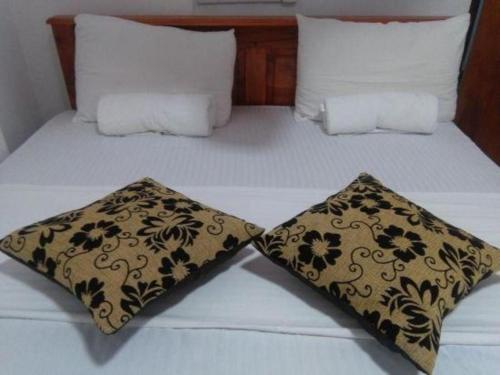 two pillows sitting on top of a bed at Hotel camorich in Debarawewa